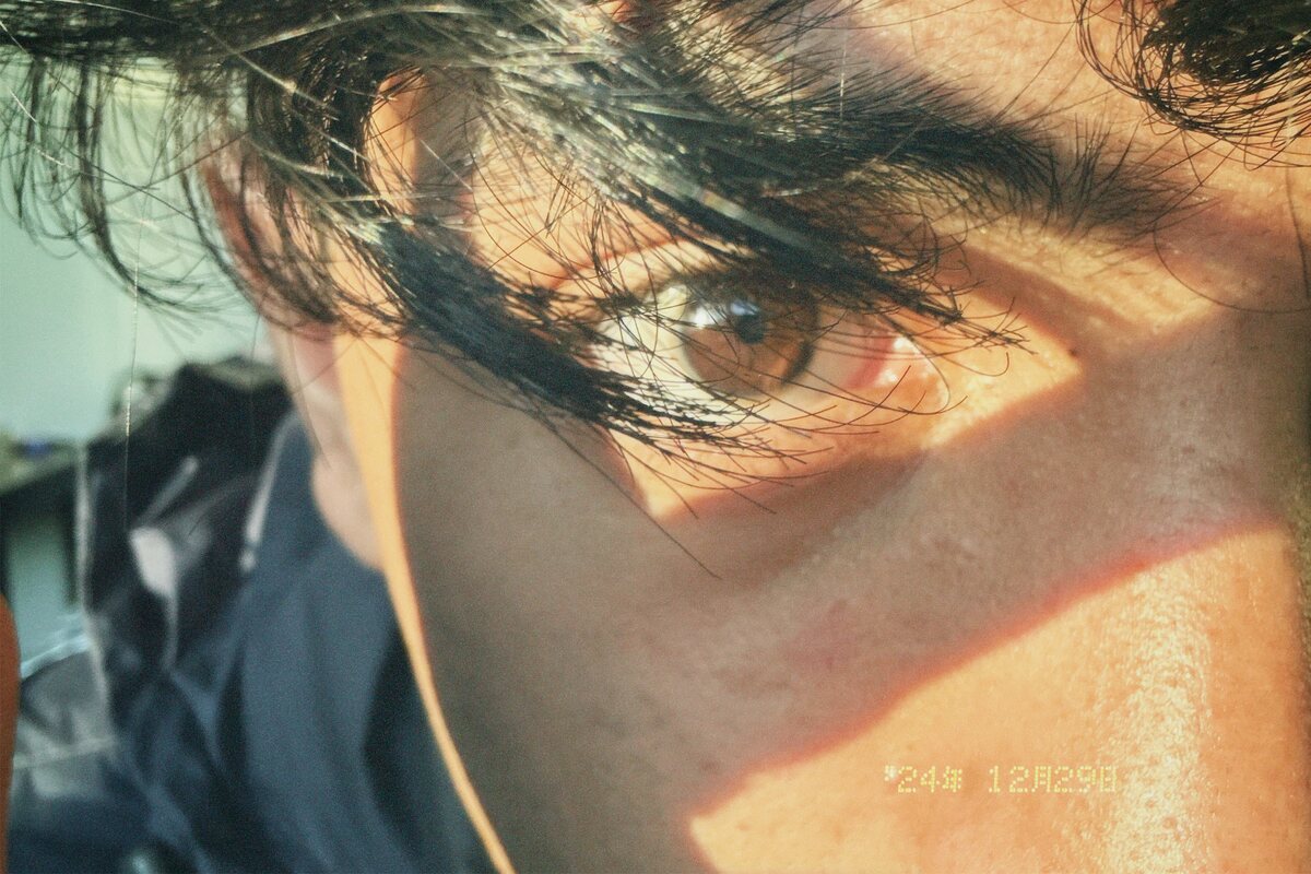 Close crop of a face in low sun, film date stamp in the corner