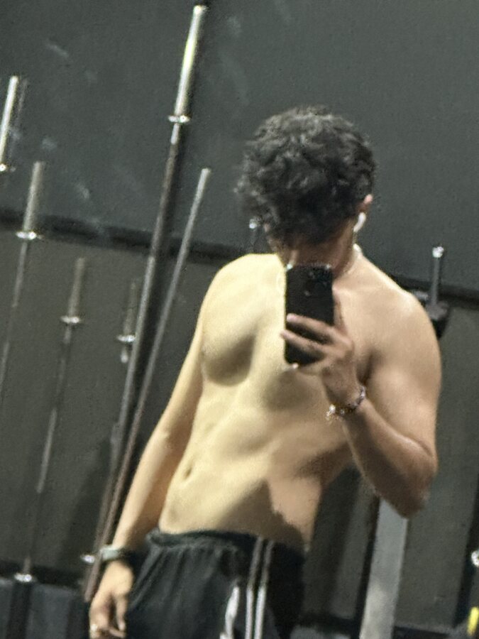Gym mirror selfie between the squat racks