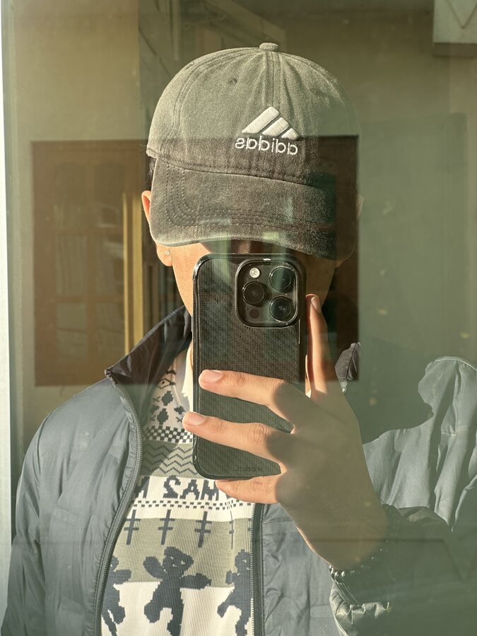 Mirror selfie in a worn adidas cap
