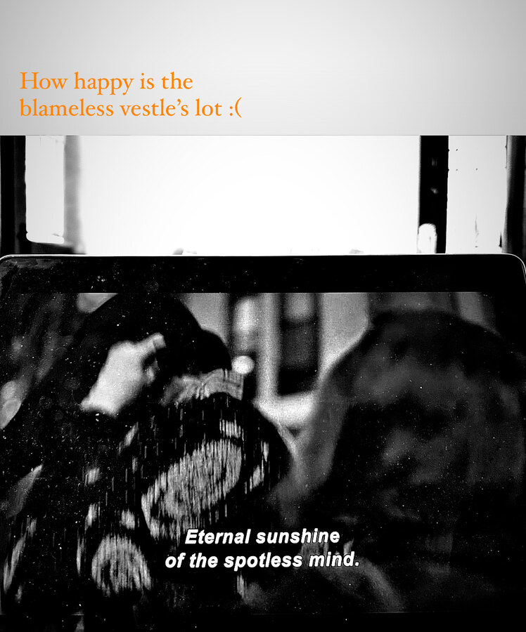 A film still playing on a laptop under a handwritten quote